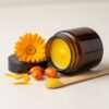 Calendula Balm Plus with bamboo spatula and ingredients