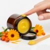 Calendula balm Plus_ woman touching the balm